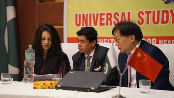 Universal Study Organization seminar with Pakistan and China flags